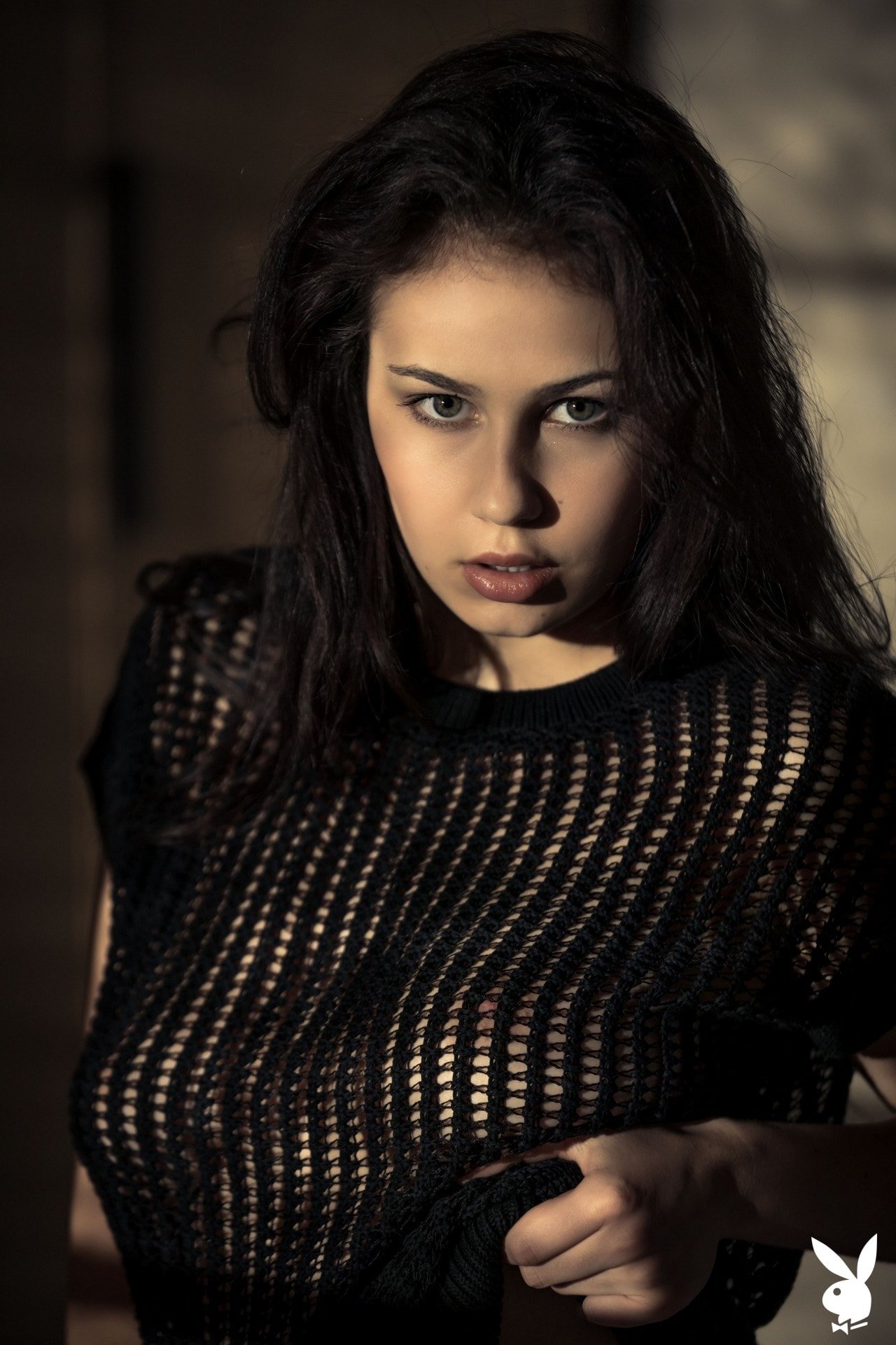 Busty all natural brunette Sophie Limma undressing in a dim room